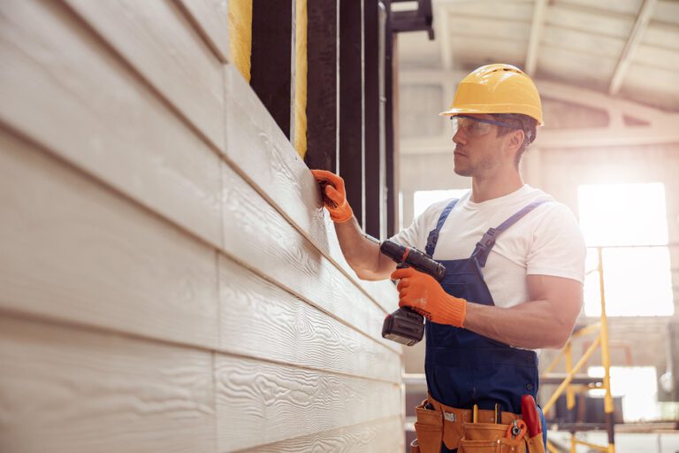 Remodeling contractor installing exterior siding on a residential home